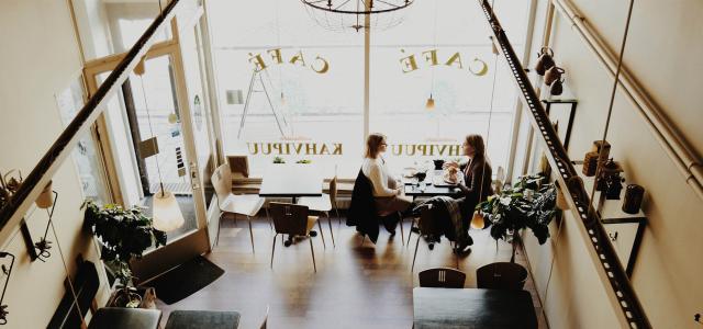 woman having coffee in small European cafe